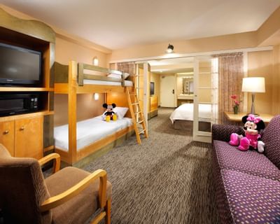 Bunk beds by a sofa in Family Suite at Anaheim Portofino Inn, an affordable hotel across from Disneyland with family suites
