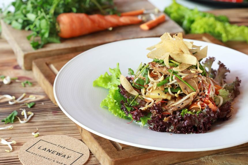 Plate of salad with fried noodles and vegetables at Laneway Restaurant & Bar