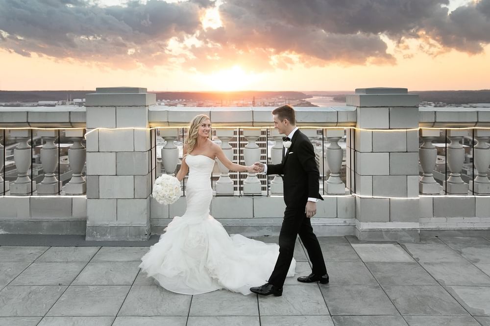 Wedded couple posing on rooftop at The Mayo Hotel