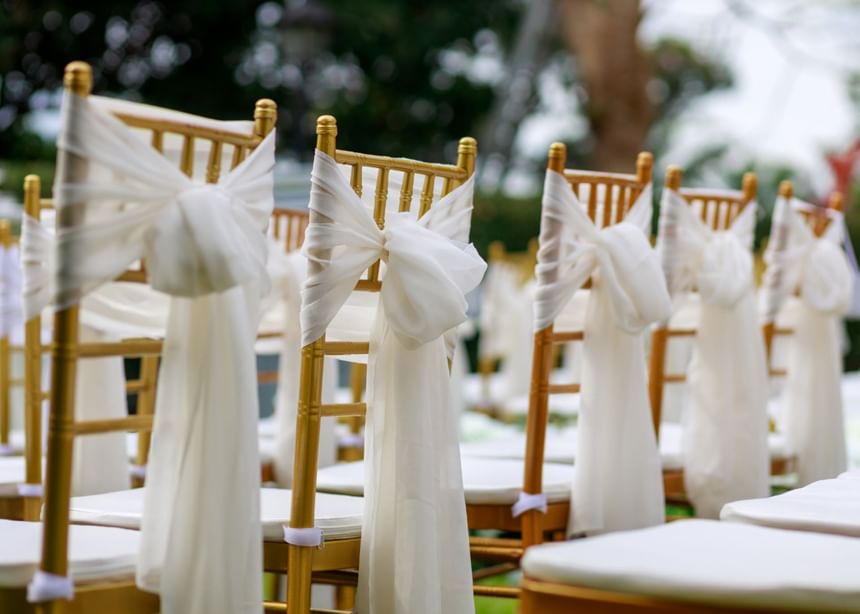 Close-up of a chairs outdoors with wedding decor at The Bethel Resort & Suites