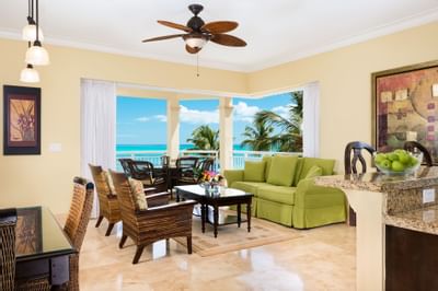 Living room with green couch in Oceanfront Deluxe Suite at Windsong Resort On The Reef