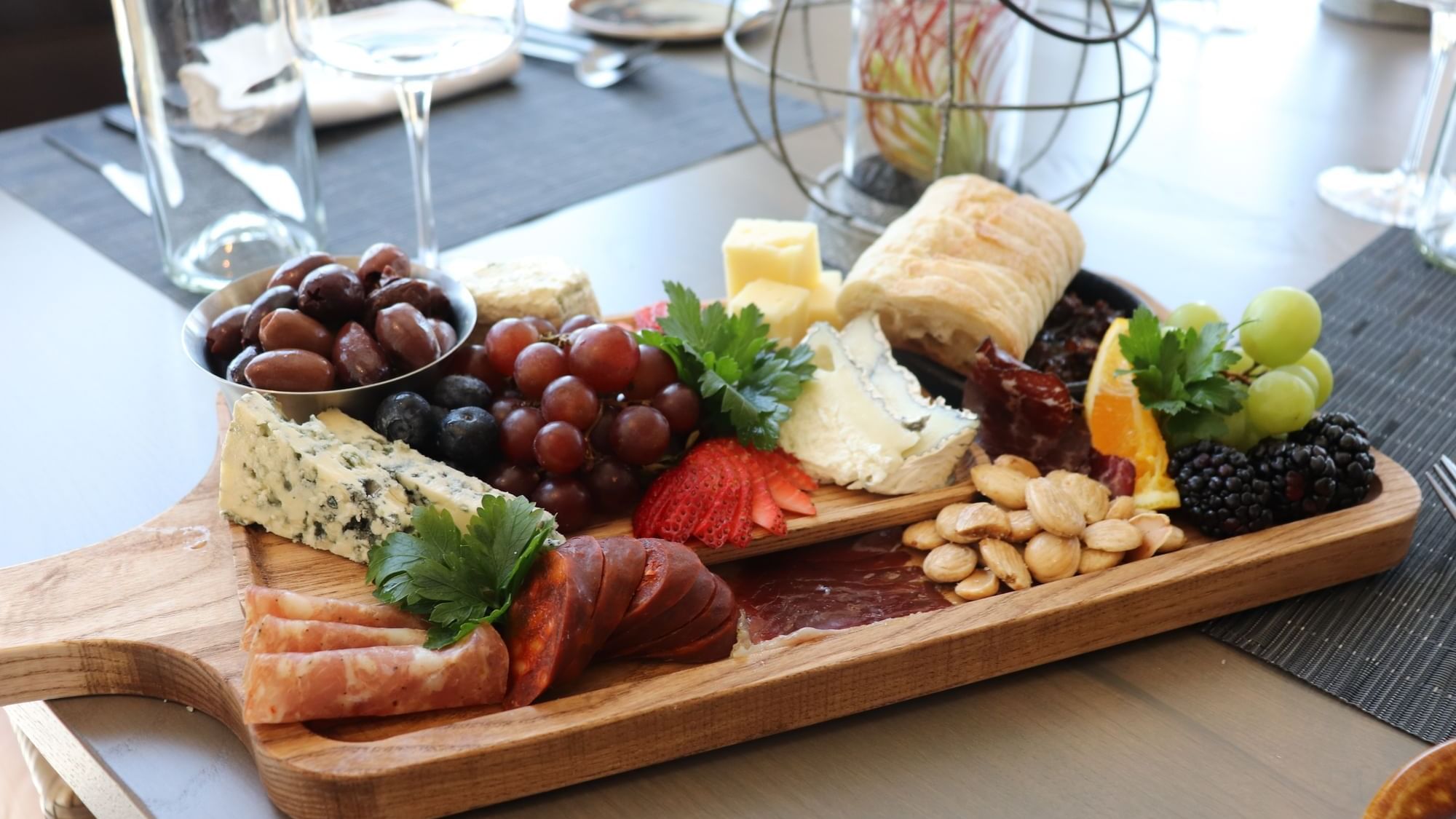 Various fruits and meats arranged on a wooden board served in 1936 at Camp Creek Inn