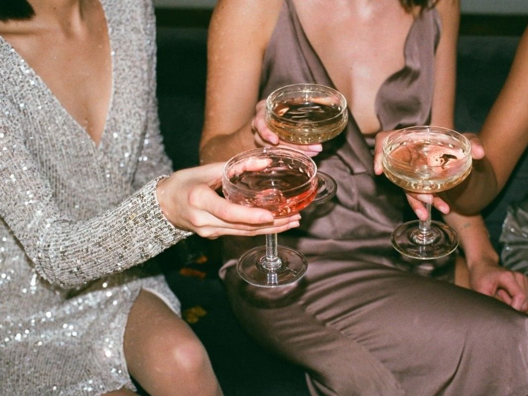 Close-up of three ladies toasting cocktails at Paradox Bangkok Sukhumvit, highlighting Bangkok hotel specials