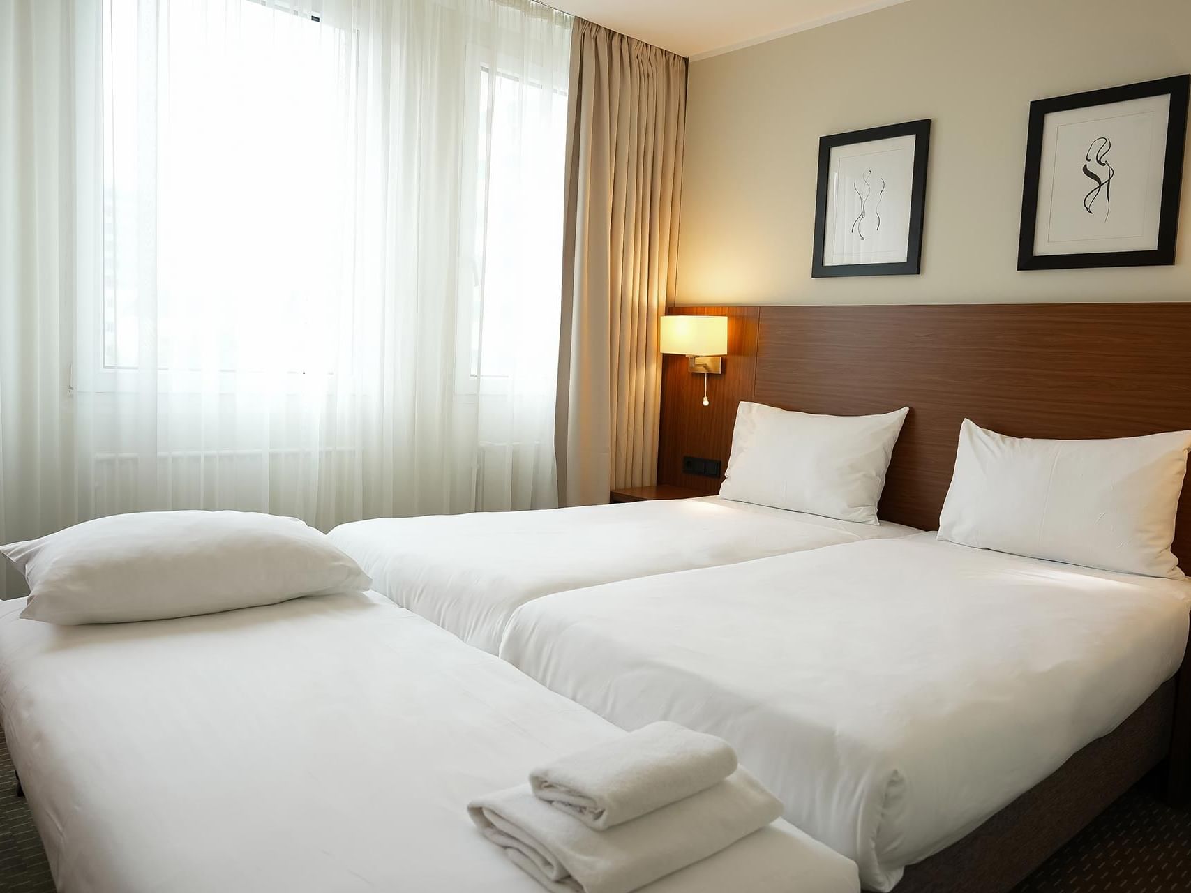 Spacious twin room with a comfortable extra bed for families at Hotel Sylter Hof Berlin