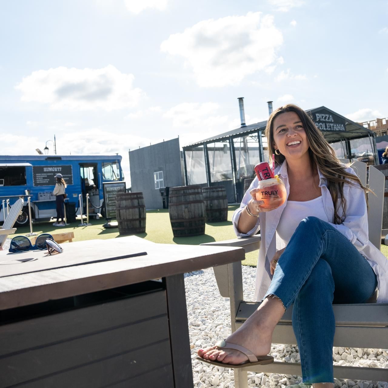 Lady with a cold drink in Beer Garden at The Artisan Hotel at Tuscan Village