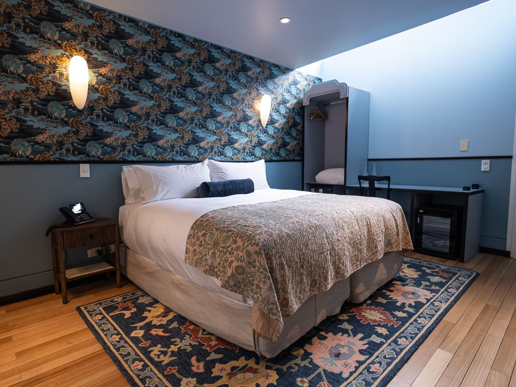 Garden Suite with a cozy bed, and an open wardrobe at The Aubrey Hotel, a boutique hotels in Santiago Chile