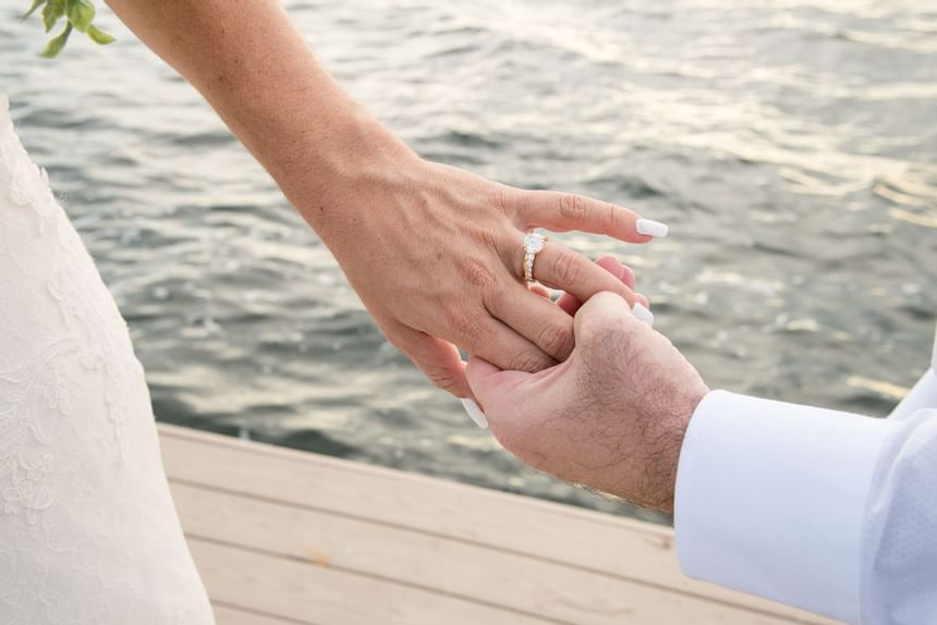 Bride holding man's hand to show off wedding ring at Bayside Inn Key Largo