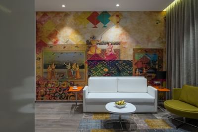 Sofa by a wall art in Suites Livingroom at Eastin Residences Vadodara