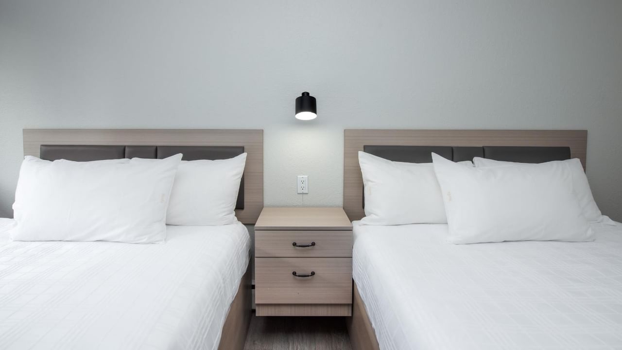 Two queen beds in a guest room at Coast Red Deer Hotel