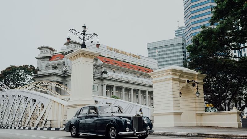 Hotel exterior with vintage Rolls Royce car at Fullerton Group