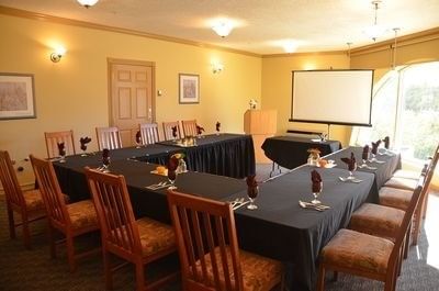 U-shaped table with black cloth facing a screen in The Shuswap at Hilltop Inn Salmon Arm