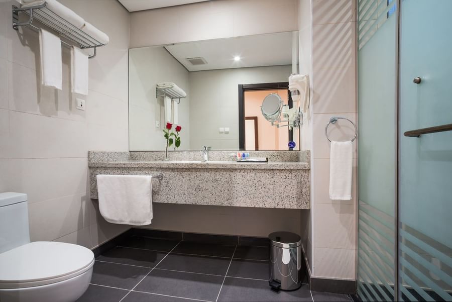 Bathroom featuring vanity and lavatory in Junior Suite at Naviti By Warwick Dammam