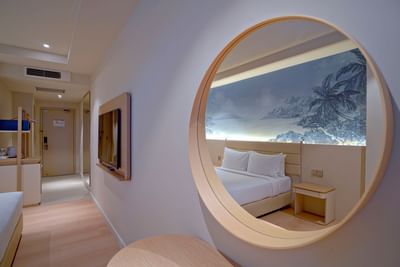 Work desk with circular mirror & TV by the bed in Superior Double at Cititel Express Kota Kinabalu