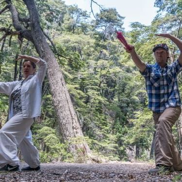 Couple doing TAI-CHI in the woods near DOT Hotels
