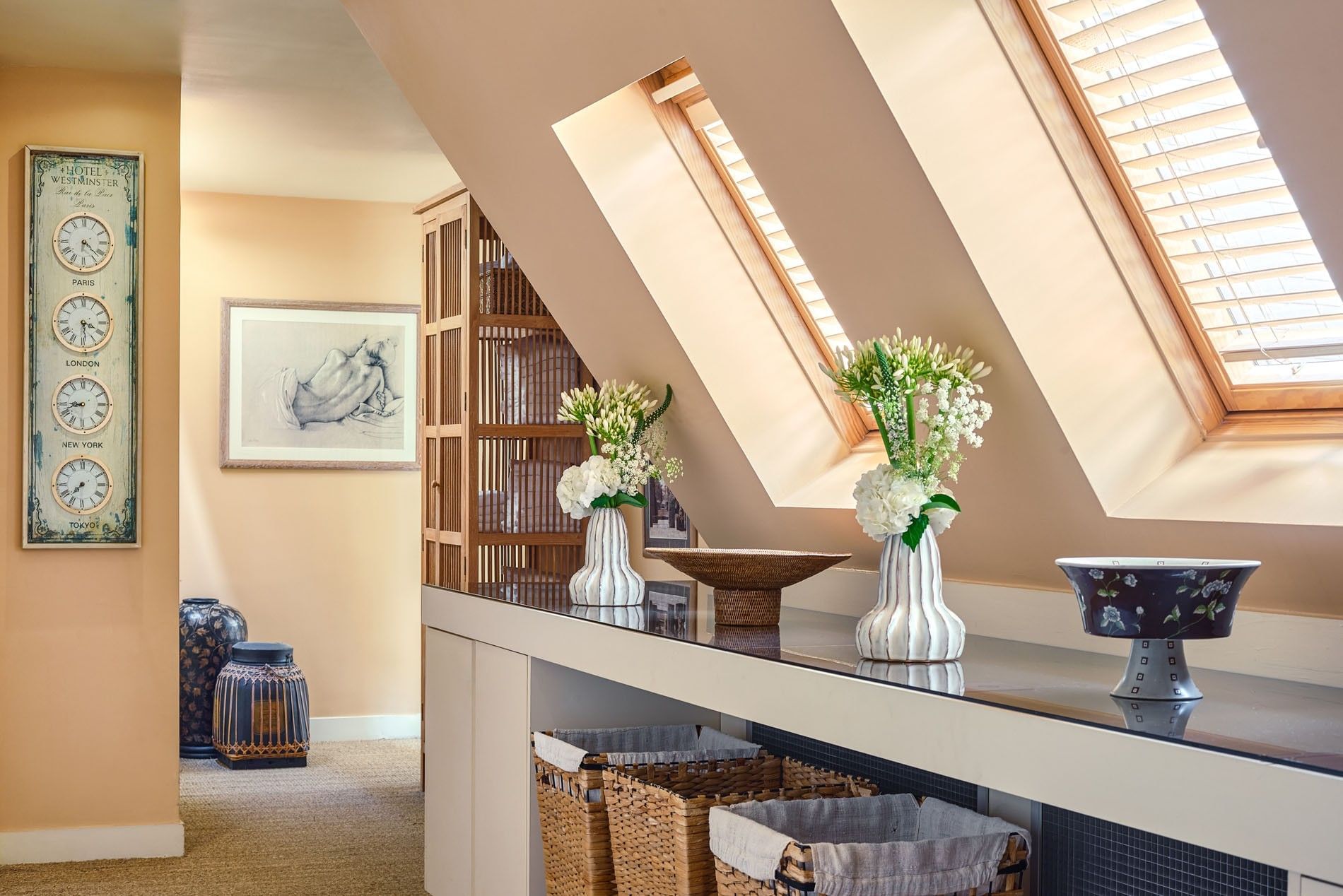 Hotel Westminster Paris spa hall featuring vases of flowers placed on a long counter, surrounded by baskets near windows