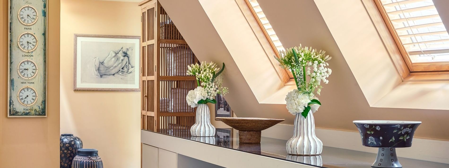 Hotel Westminster Paris spa hall featuring vases of flowers placed on a long counter, surrounded by baskets near windows