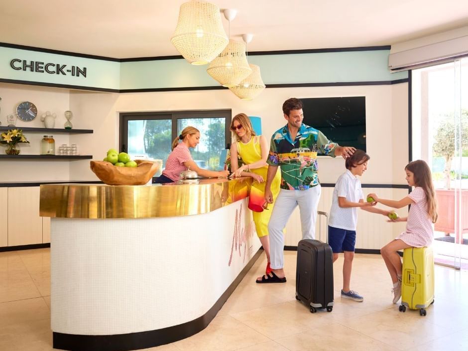 Family of four checking in by the hotel reception at The Magnolia Hotel