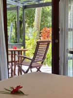 Garden View Room with wooden furniture and tropical garden view at Warwick Fiji Resort and Spa, Korolevu.