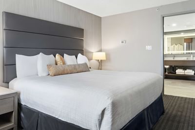 bed in modern hotel room with door to bathroom