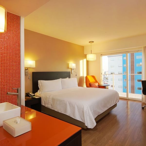 Interior of Deluxe King Room with balcony at Fiesta Inn
