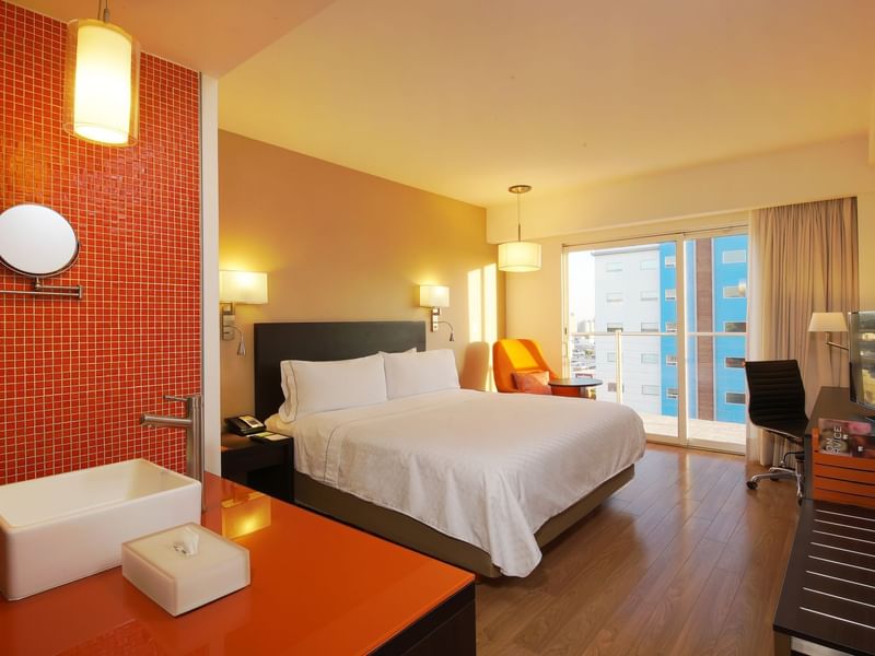 Interior of Deluxe King Room with balcony at Fiesta Inn