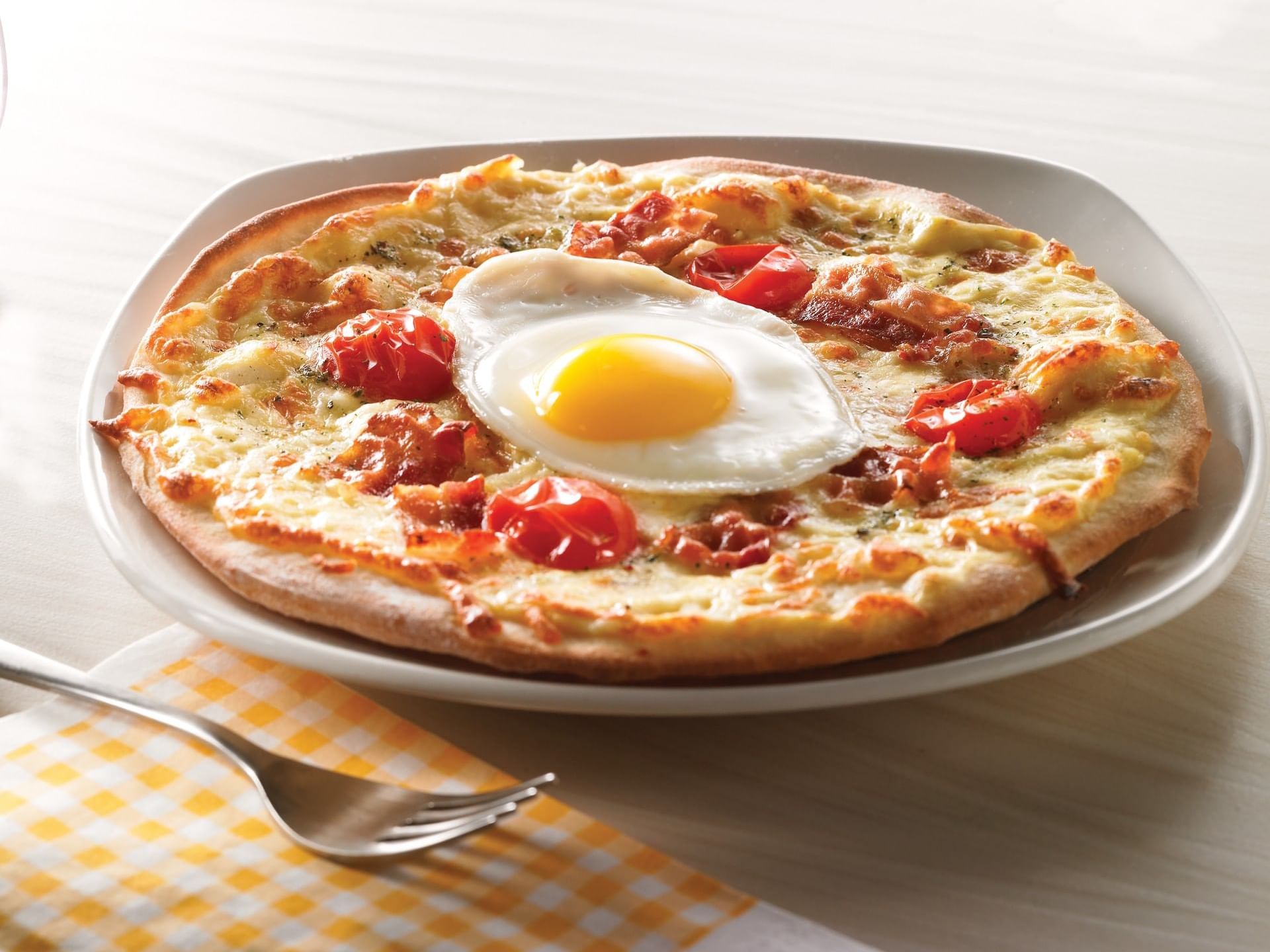 A fine breakfast pizza served at Clique Hotels & Resorts