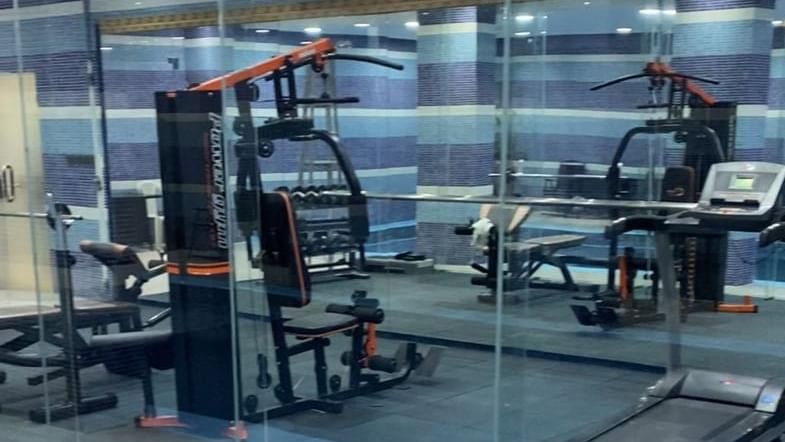 Well-equipped gym overlooking the pool at Warwick Hotels and Resorts