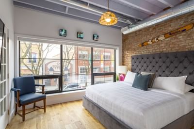 Bedroom with large windows in Apartment 199B at Retro Hotel