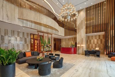 luxurious hotel lobby with sitting area and reception desks