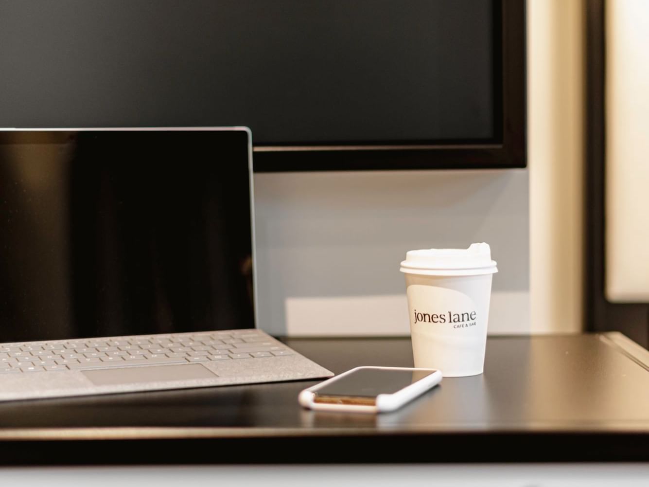 Laptop, mobile and coffee cup on a table at Brady Hotels