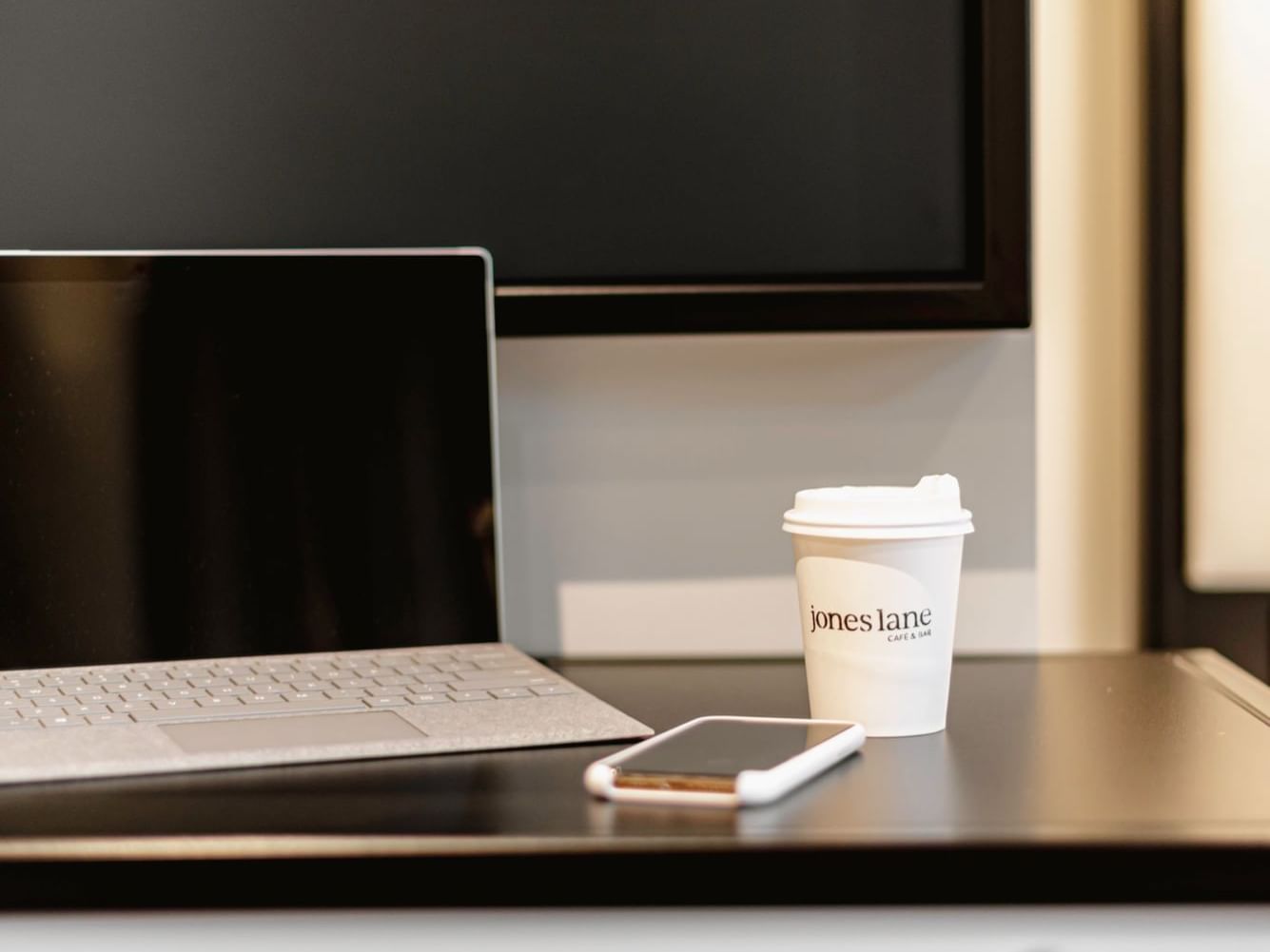 Laptop, mobile and coffee cup on a table at Brady Hotels Jones Lane