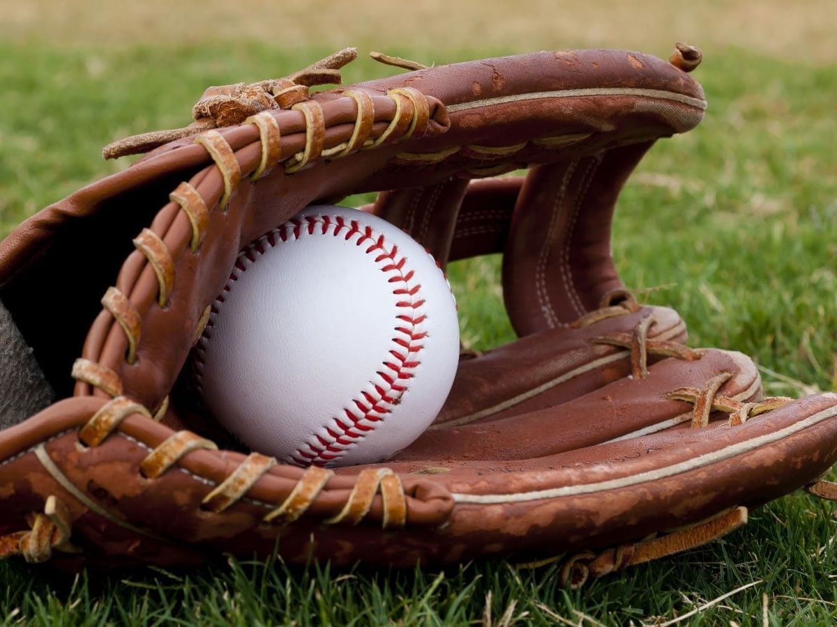 Close-up of baseball and glove at Fray Nano Baseball Stadium near Grand Fiesta Americana