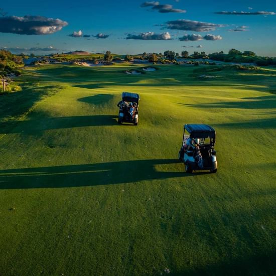 Golf buggies driving around Golf Course  near Pullman Magenta Shores Resort