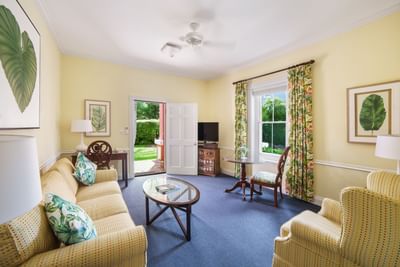 living room with yellow furniture and blue carpet