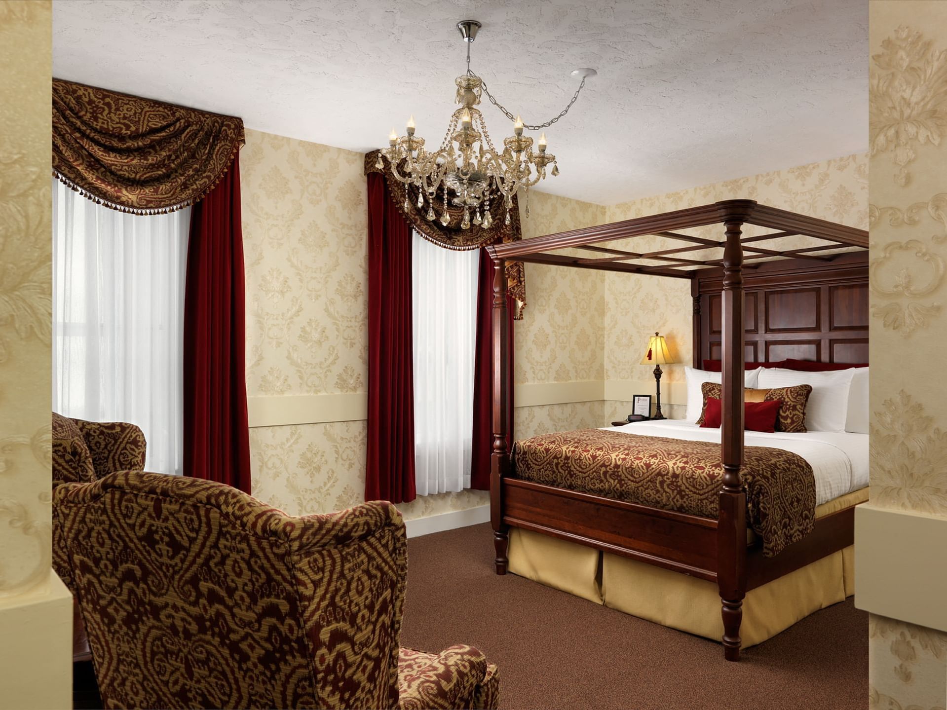 Queen bed with cozy lounges in Notre Dame Room at Pendray Inn & Tea House