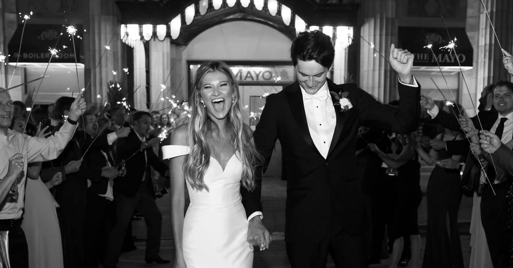 Wedded couple exiting their reception at The Mayo Hotel