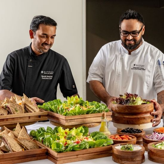 Chefs arranging salads and sandwiches area of the buffet at Pullman Sydney Hyde Park