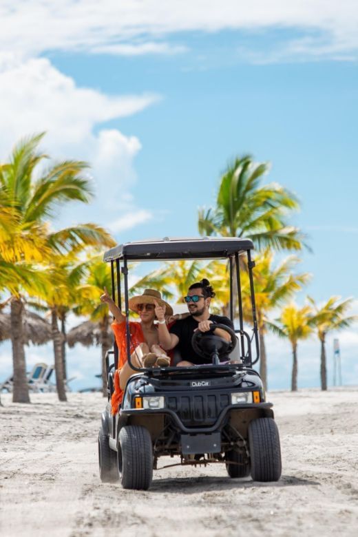 Couple driving a cart exploring the surrounding on the beach at Playa Blanca Beach Resort