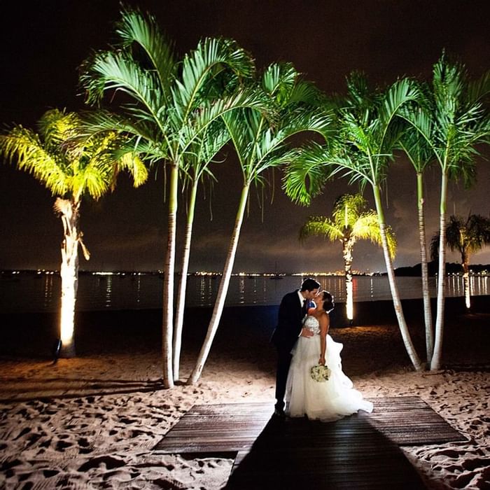 outdoor wedding scene with trees and bride and groom