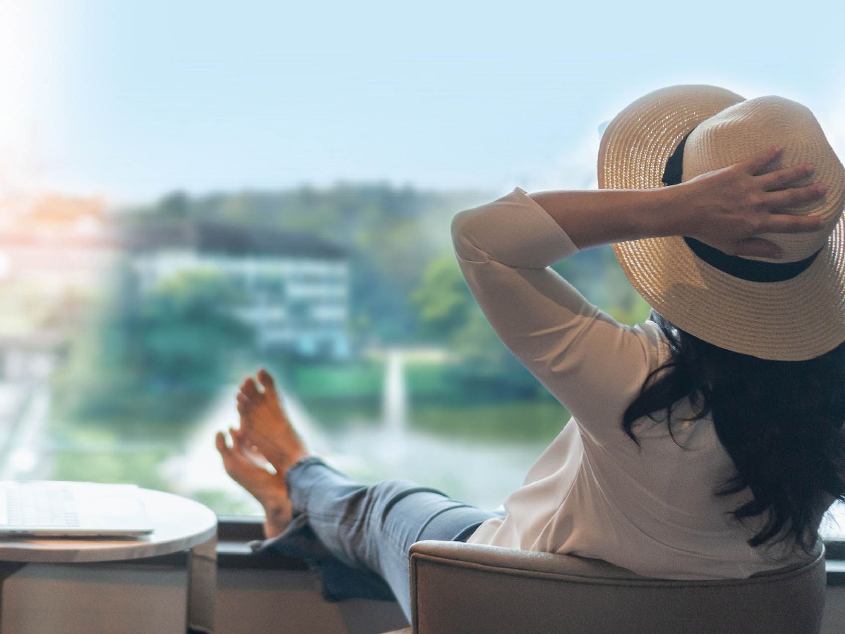 Lady lounging on a chair while enjoying the outdoor view at Saujana Hotel Kuala Lumpur