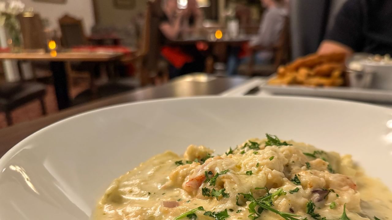 A close-up of a creamy seafood dish in a bowl.