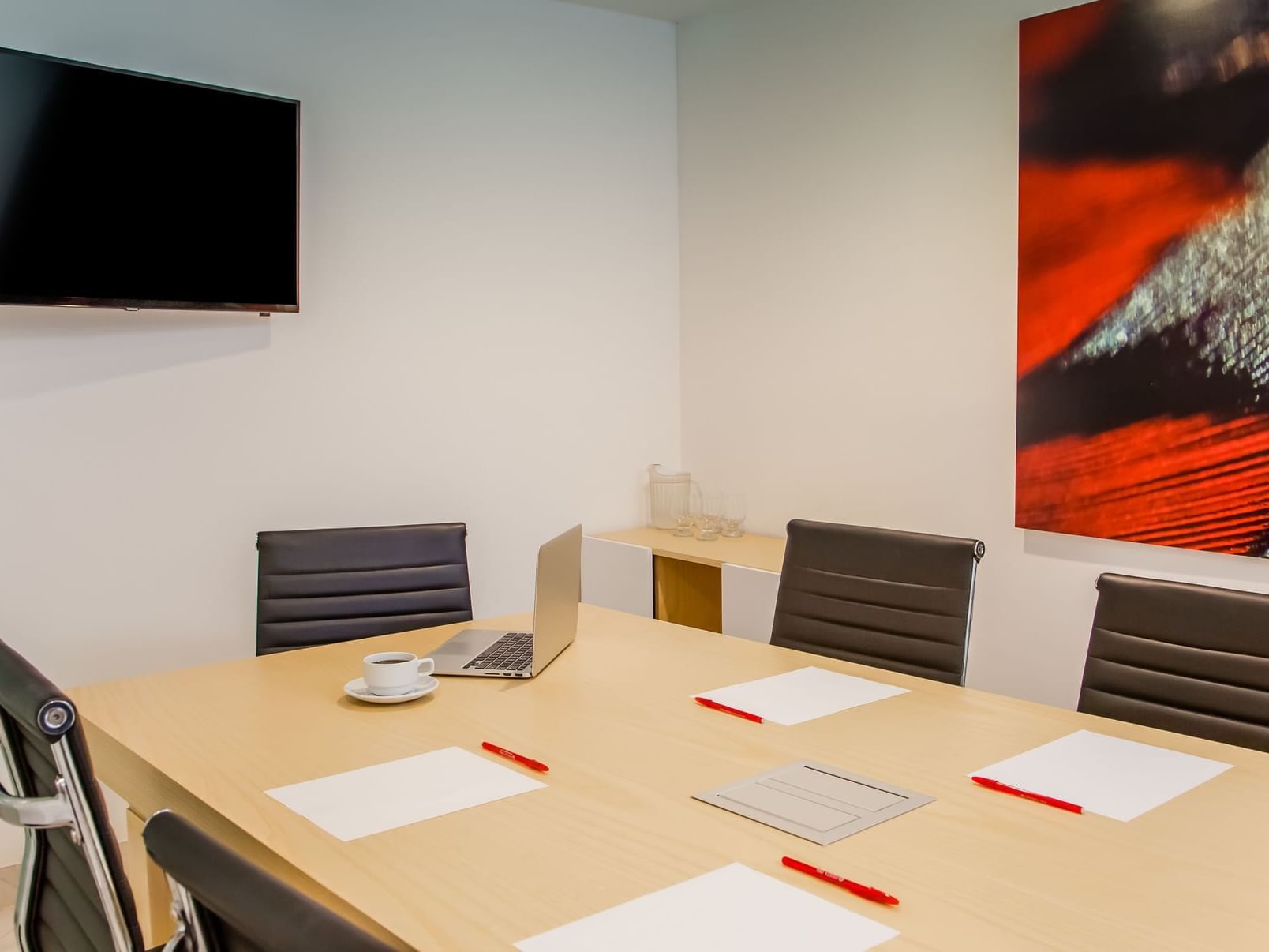 Conference table & a Tv in a Business Centre at Fiesta Inn