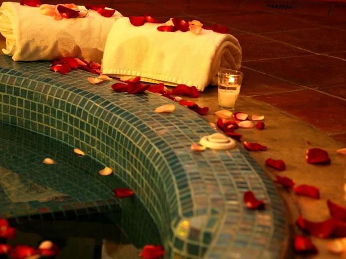 Lit candles & petals by the Jacuzzi at FA Hotels & Resorts