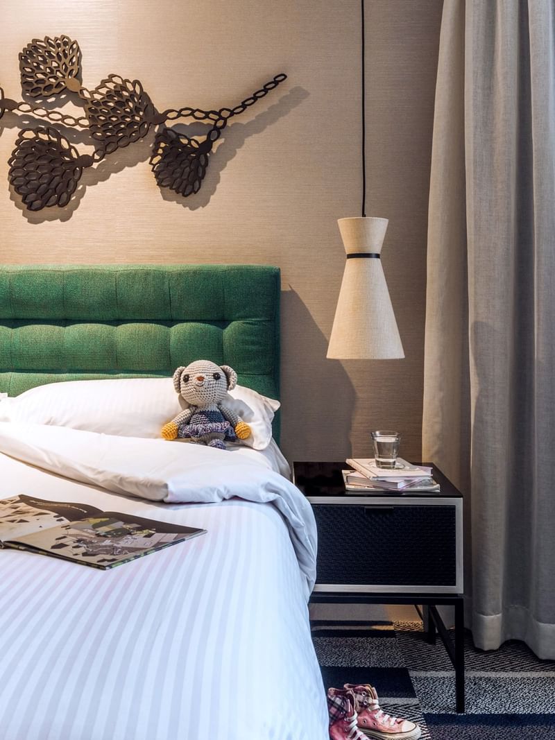 A toy on a bed in the bedroom at Crown Promenade Perth