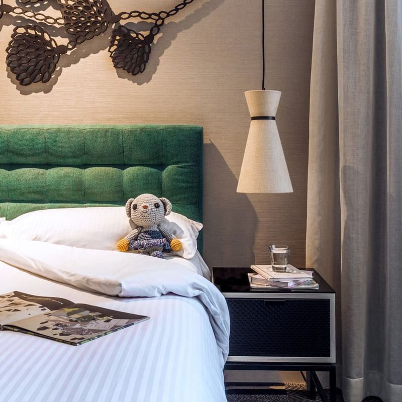 A toy bear on a bed in bedroom at  Crown Promenade Perth