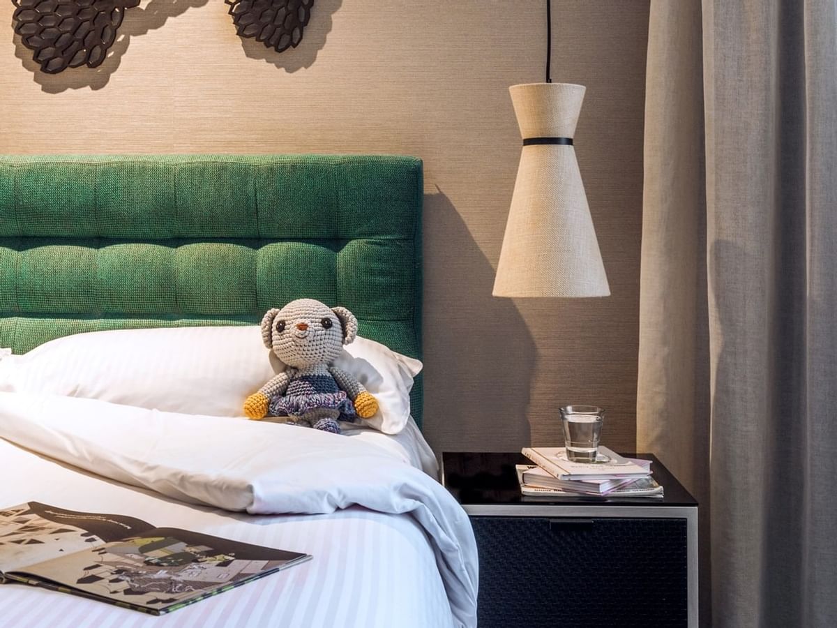 A toy bear on a bed in bedroom at  Crown Promenade Perth