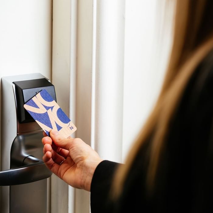 Lady opening door using a keycard at Novotel Glen Waverley