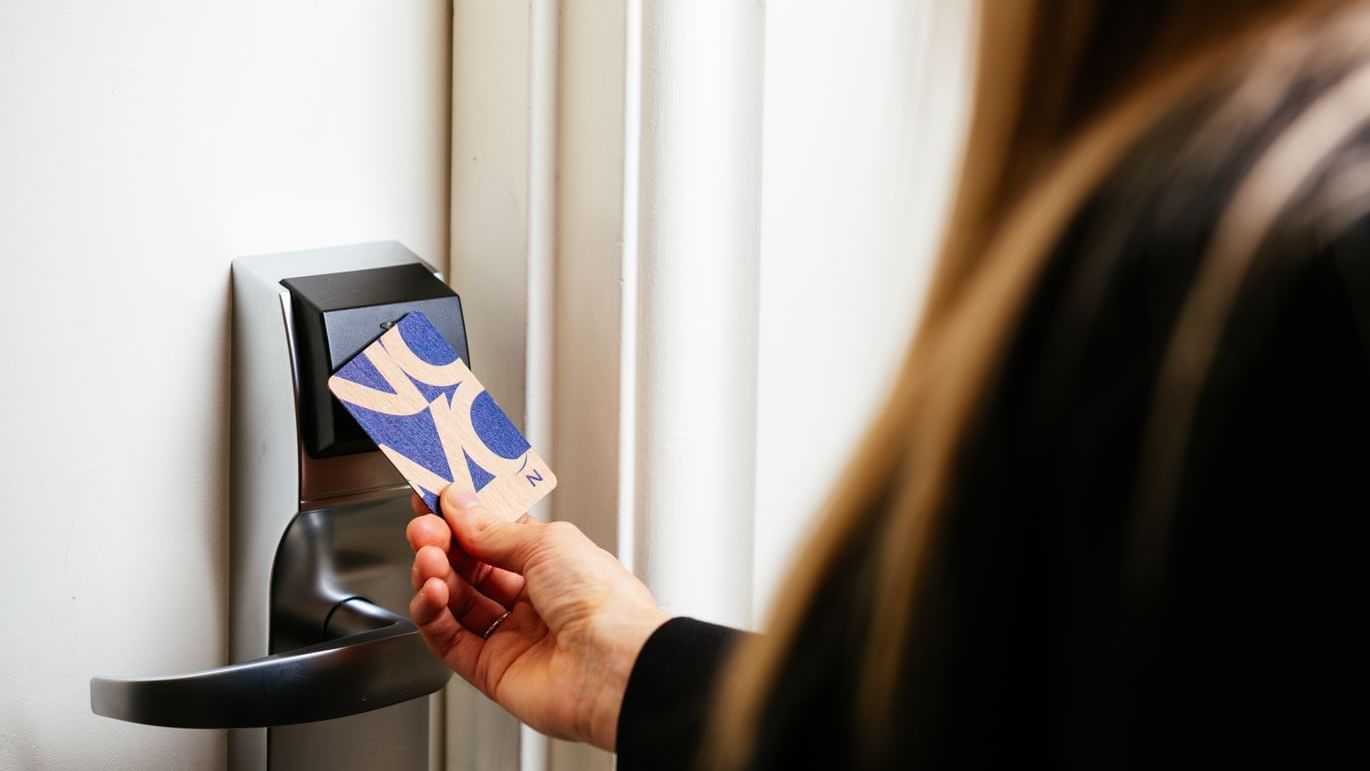 Lady opening door using a keycard at Novotel Glen Waverley