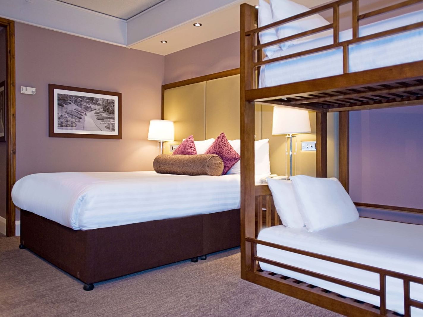 The Family King Room at Sandman Signature London Gatwick Hotel with one king bed (with premium pillow-top) and two bunk beds