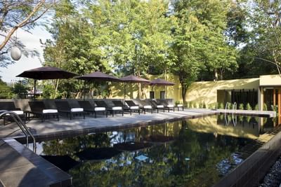 Swimming pool & lounge chair at U INCHANTREE KANCHANABURI